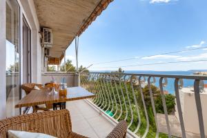 a balcony with a table and chairs and the ocean at Apartment Maya in Podstrana