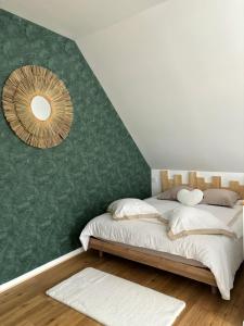 a bedroom with a bed with a green wall at LE 911 in Nazelles