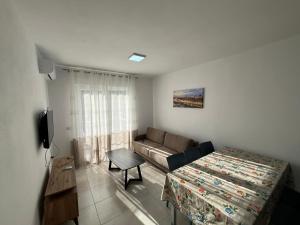 a small living room with a couch and a table at Banesa me qera in Margjonaj