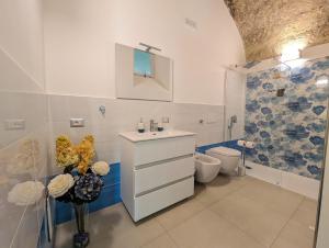 a white bathroom with a sink and a toilet at Louis House ad Agerola per Amalfi Positano Pompei in Agerola