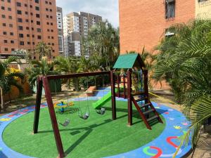 a playground with a slide and a swing at Apartamento Maracay Base Aragua in Maracay