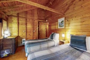 a bedroom with two beds in a log cabin at Charming South Bristol Cottage in South Bristol