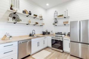a kitchen with white walls and stainless steel appliances at Eternal Romance-The Honeymoon Suite at 1885 Farms in Navarre
