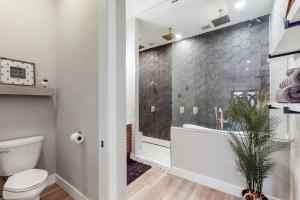 a bathroom with a shower and a toilet and a tub at Eternal Romance-The Honeymoon Suite at 1885 Farms in Navarre