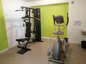 a gym with two exercise bikes and a treadmill at T1 avec piscine et terrasse au coeur de La Rochelle in La Rochelle