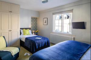 a bedroom with two beds and a window at Dream Stays Bath - Trim Street (Hot tub) in Bath