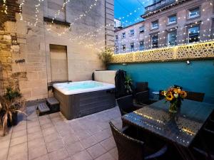 a hot tub sitting on top of a building at Dream Stays Bath - Trim Street Townhouse with Hot tub in Bath