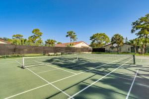 a tennis court with a net on it at Sarasota Villa with Pool Access about 4 Mi to Beach! in Sarasota
