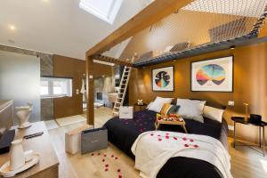 a bedroom with a bed and a staircase in it at Relax House & SPA - DISNEY in Crecy la Chapelle