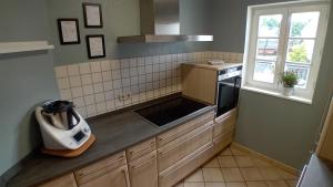 a kitchen with a sink and a stove at Ferienwohnung in der Jeeßjass in Bleialf