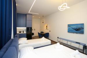 a hotel room with two beds and a table at Sea La Vie in Vlorë