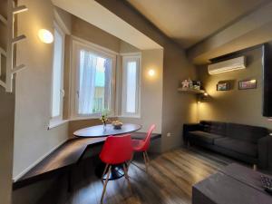 a living room with a table and chairs and a couch at Primo Passo The Lorax in Arco