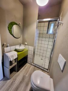 a bathroom with a sink and a toilet and a mirror at Primo Passo The Lorax in Arco +6 photos