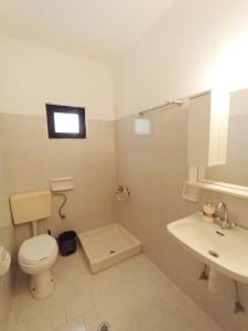 a bathroom with a toilet and a sink at Horizon Blue in Loutsa +23 photos