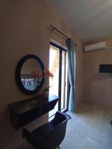 a bathroom with a mirror and a chair and a sink at Horizon Blue in Loutsa