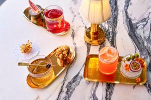 a table topped with plates of food and drinks at Le Meridien New York, Central Park by Marriott in New York