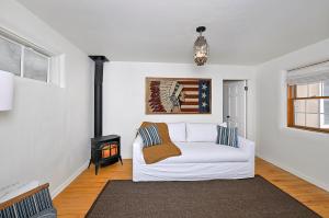 sala de estar con sofá blanco y chimenea en Dos Hermanas Casita 3 Downtown 1BR/1B, en Santa Fe