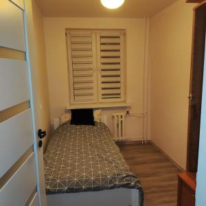 a bedroom with a bed in a room with a window at Gruntowa u Joli in Białystok