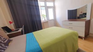 a bedroom with a bed and a dresser and a window at Feeling at home in İstanbul Center 5 Minutes walk to The Ataköy Metro Station & Metrobus in Istanbul