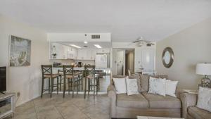 a living room with a couch and a kitchen at Cabana Club 206 Gulf Oceanfront, King Bed, private beach in Destin
