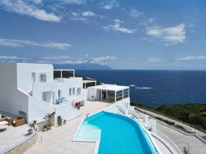 an external view of a villa with a swimming pool at Cavo del Sol in Sarti
