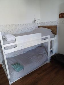 a white bunk bed in a room at Voyage Hostel - Ensuite Family Rooms with shared kitchen in Douglas