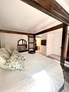 a bedroom with a large white bed with pillows at The Savannah Suite in Winona
