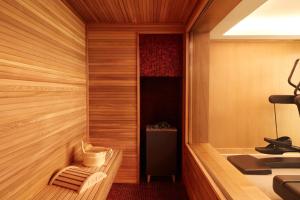 a room with a sauna with a chair and a table at Hotel La Villa Saint Germain Des Pr&eacute;s in Paris