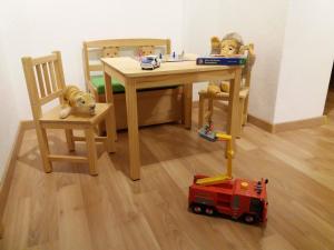 a wooden table with two chairs and a toy train at Ferienhaus Johanna in Alberthain