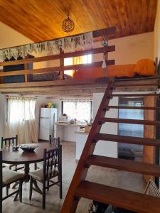 a kitchen and dining room with a loft bed and a table at Supernova - Gualeguay in Gualeguay