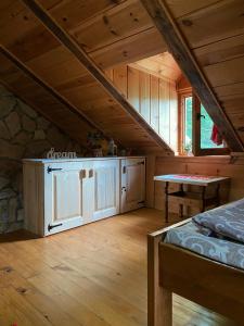 Cette chambre mansardée comprend un lit et une table. dans l'établissement Drinska Villa Cabin, à Perućac