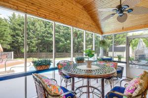 a screened in porch with a table and chairs at Home Sweet Home with Private Pool and Patio! in Knoxville