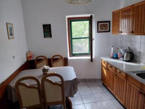 a kitchen with a table and chairs and a window at Art House Old Village in Jesenice +32 photos