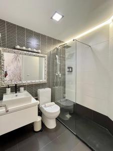 a bathroom with a toilet and a sink and a shower at WeRentVLC - Design Ruzafa - Top location in Valencia