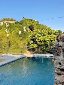a pool of water in front of a hill at Casa Rural Pernales II in Ruidera