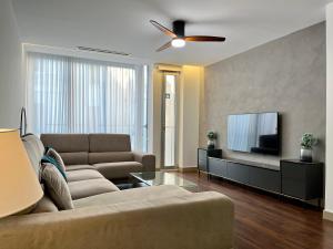 a living room with a couch and a flat screen tv at WeRentVLC - Design Ruzafa - Top location in Valencia