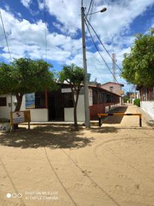 an empty street with trees and a street light at Pousada Galinhos in Galinhos
