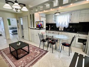 a kitchen with a table and chairs and a dining room at Bratis House Arkoudi in Arkoudi