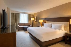 a hotel room with a large bed and a television at DoubleTree by Hilton Washington DC – Crystal City in Arlington
