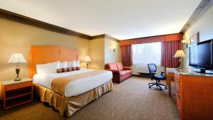 a hotel room with a large bed and a television at Abercorn Hotel, Trademark Collection by Wyndham in Richmond