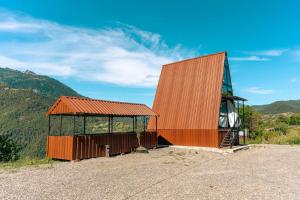 a small building on top of a hill with mountains at Paradise Keda in K'eda