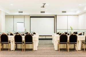 a conference room with tables and chairs and a whiteboard at Loi Suites Recoleta Hotel in Buenos Aires +106 photos