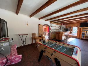 a room with a ping pong table in it at LE CHAMOIS in La Poutuire