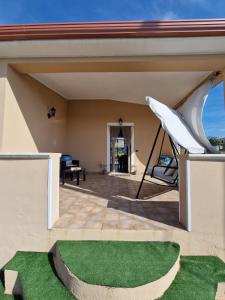 a patio with a hammock on a house at Curmo beach & relax in Le Castella