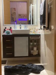 a bathroom with a sink and a mirror at NuriahBoutique Sacavém in Sacavém