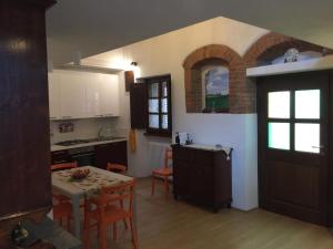 a kitchen with a table and chairs and a dining room at Villa Marta in Contignano