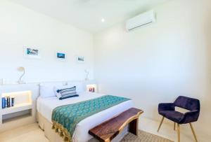 a bedroom with a bed and a chair at Casa Imox Holbox, apartment 1 in Holbox Island
