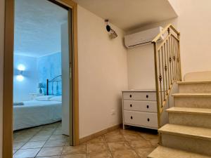 a bedroom with a bed and a stairway leading to a bedroom at Il Golfo di Cofano in Custonaci