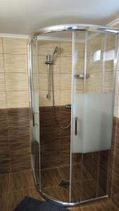 a shower with a glass enclosure in a bathroom at Dunaparti vendégház in Ráckeve