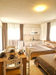 a hotel room with two beds and a table and chairs at IVANA Apartments in Ulcinj